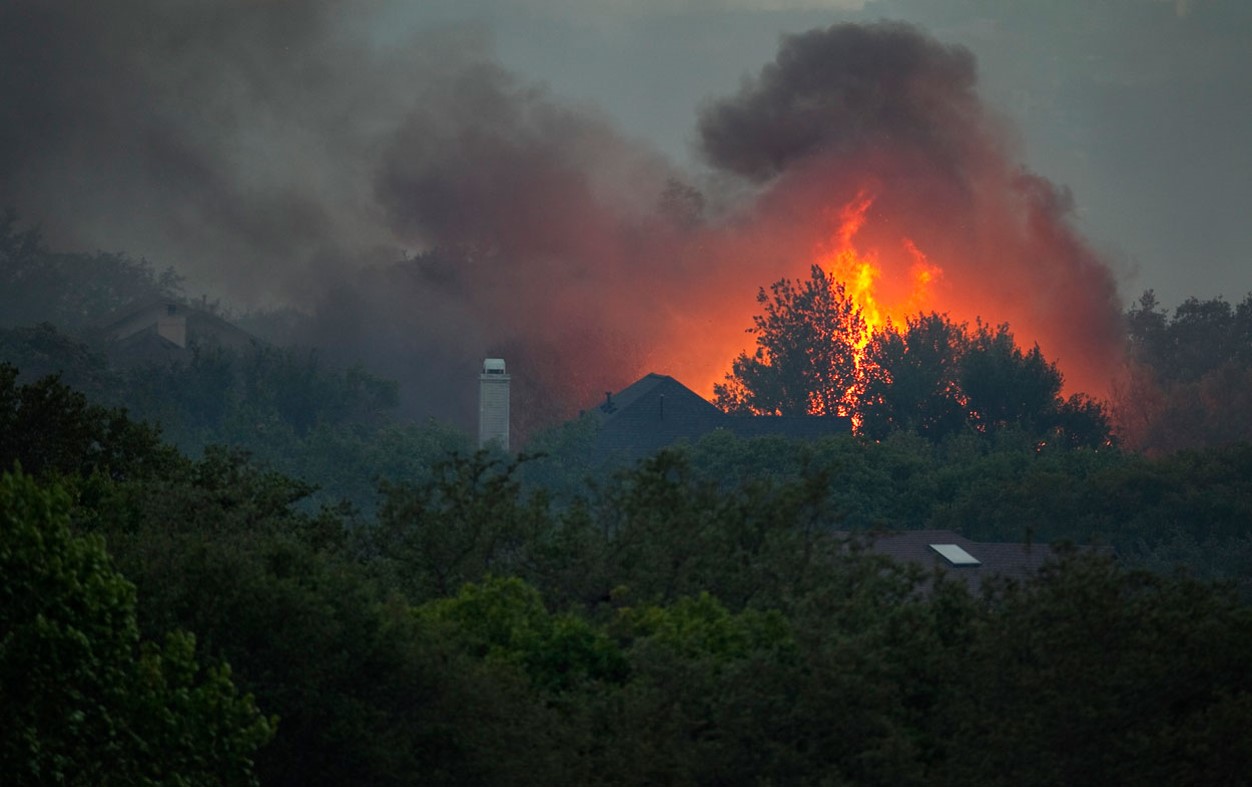 HOMES BUILT IN DENSE VEGETATION WITH WILDFIRE QUICKLY APPROACHING